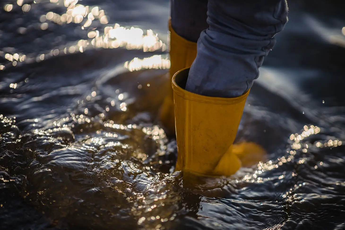 Young child standing in flood waters